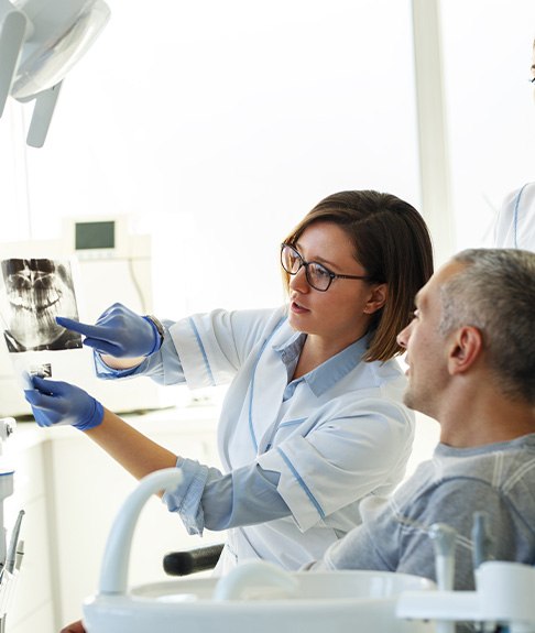 Patient in Lakewood talking to dentist about dentures