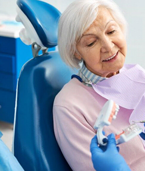 senior female dental patient listening to dentist explination of treatment