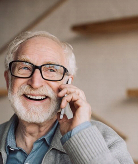 smiling senior man conversing on phone