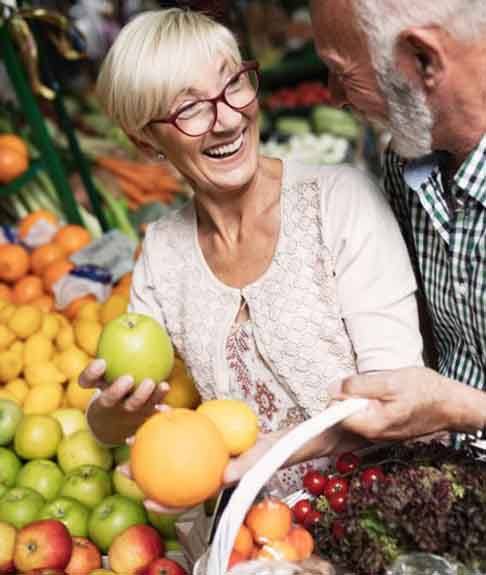 an older couple shopping for healthy food