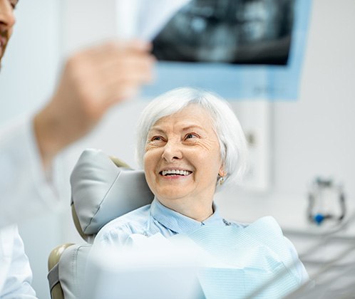 dentist showing x-ray to patient